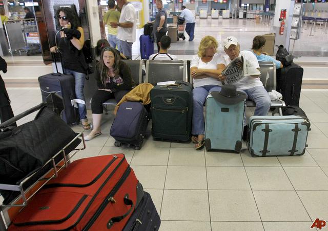 Passengers stranded by the collapse of XL Leisure Group are seen at Larnaca airport, Cyprus, Friday, Sept. 12, 2008. Thousands of British travelers are stranded as the country's third-largest tour operator has collapsed under pressure from high fuel prices and a sagging economy. XL Leisure Group PLC went into administration overnight, saying it had been unable to secure more funding. (AP Photo/Petros Karadjias)